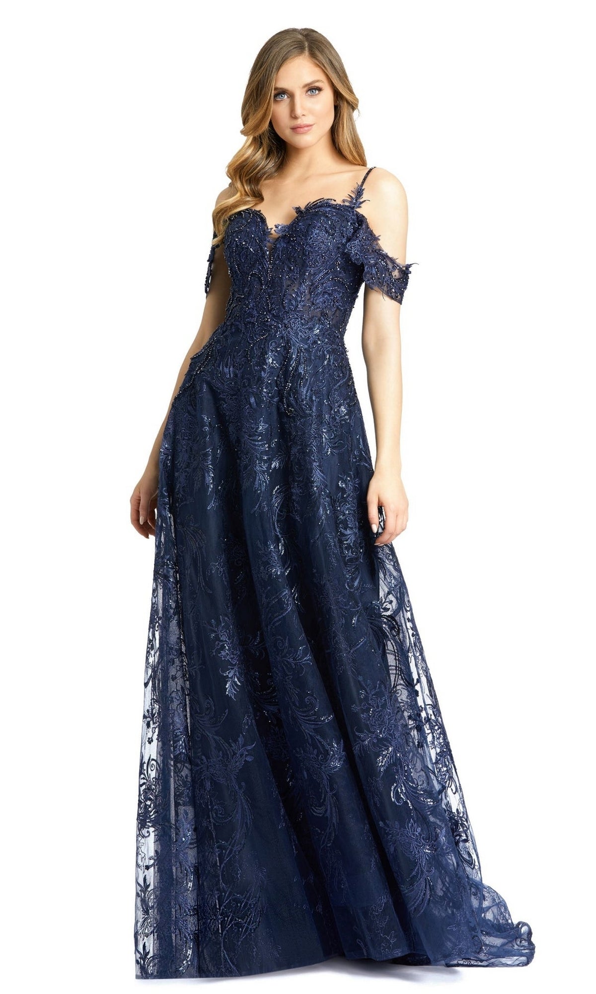 A woman wearing the Long Formal Dress 20287 by Mac Duggal, featuring an embroidered navy blue A-line silhouette with a sweetheart neckline, off-the-shoulder floor-length lace design, and intricate semi-sheer overlay.
